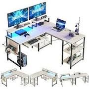 computer desks with multiple monitors and keyboards on each one, all in different positions