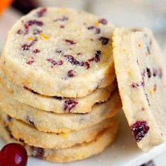 cranberry orange shortbread cookies stacked on top of each other