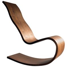 the curved wooden chair is made from wood