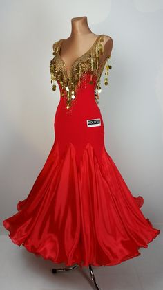 a red evening gown with gold sequins on the shoulders and neckline is displayed