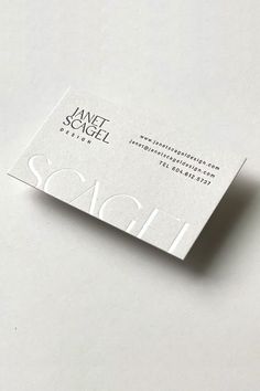 a white business card sitting on top of a table