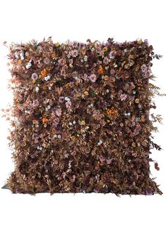 a decorative pillow made out of dried flowers