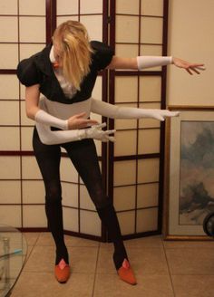 a woman dressed in black and white is balancing