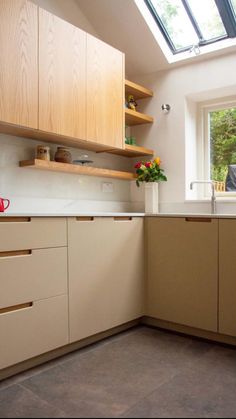 a kitchen with an open skylight above the sink