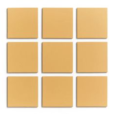 six square pieces of tan colored paper on a white background