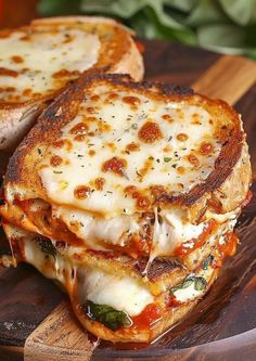 two grilled sandwiches stacked on top of each other with melted cheese and tomato sauce