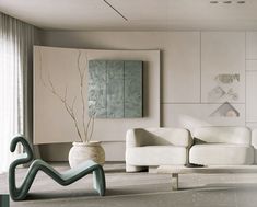 a living room filled with white furniture next to a window