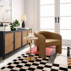 a living room with a black and white checkered rug on the floor next to a brown chair