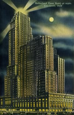 an old postcard shows a large building in the middle of a city at night