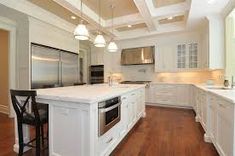 a large kitchen with white cabinets and an island