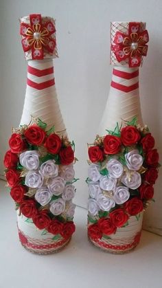 two wine bottles decorated with red and white flowers