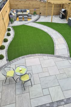 an outdoor patio with grass and seating area