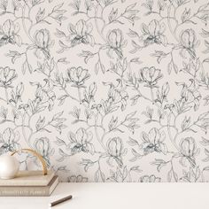 the wallpaper is white and has flowers on it