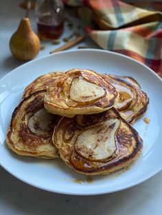 some pancakes on a white plate with syrup