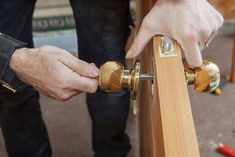 a man is working on a piece of wood