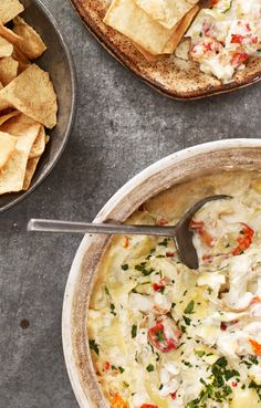 two bowls of soup with tortilla chips on the side and one bowl filled with quesadilla