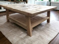 a wooden table sitting on top of a rug