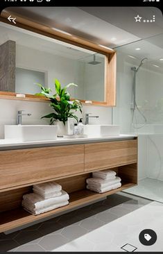 a bathroom with two sinks and a large mirror