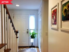 a hallway with white walls and wooden steps leading up to the front door is shown