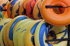 an assortment of inflatable boats are lined up