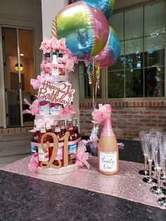 a table topped with lots of bottles and balloons