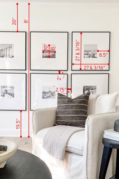 a living room filled with white furniture and pictures on the wall above it's coffee table