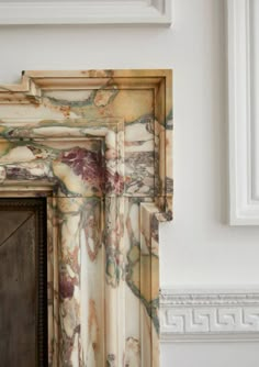 an old fireplace with marbled paint on it