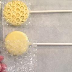 three lollipops sitting on top of plastic wrappers