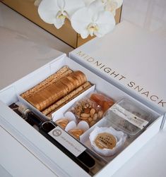 an open white box filled with different types of food