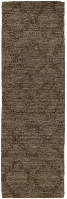 a brown rug with an intricate design on the front and back side, in two different colors