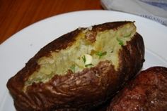 two stuffed potatoes on a white plate