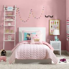 a bedroom decorated in pink and white with cupcakes on the wall above the bed