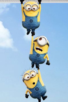 two minions from despicable memes hanging upside down in the air with their eyes wide open