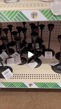 there are many black candles on the shelf