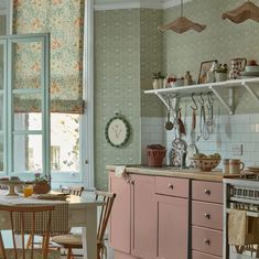 the kitchen is clean and ready to be used for cooking or baking, with pastel pink cabinets