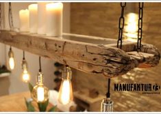 some lights hanging from a wooden beam in a room