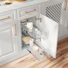 an open dishwasher door in a kitchen with white cabinets and wood flooring