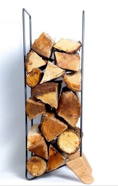 a stack of logs with a wooden spatula in front of it on a white background