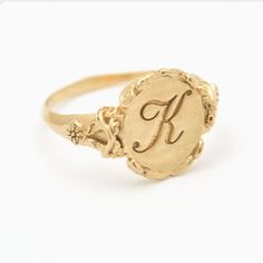 This vintage style signet ring is inspired by 17th-century Italian  Baroque architecture, featuring beautiful little fluorishes all around the center which displays your personal monogram or initials. This ring can be customized with any letter or word (provided it fits) and is made in solid gold. This ring can be made for men or women and in your preferred size or color of gold. A phrase or letter may be written on the inside, too!All designs are modelled and sent to you for approval before cas K Signet Ring, Luxury Vintage Signet Ring With Engraving Option, Vintage Signet Ring With Intricate Design, Victorian Round Signet Ring With Engraving Option, Vintage Gold Monogram Ring, Victorian Signet Ring With Engraving Option For Wedding, Antique Personalized Yellow Gold Signet Ring, Antique Initial Ring In 14k Gold, Victorian Yellow Gold Signet Ring With Initials