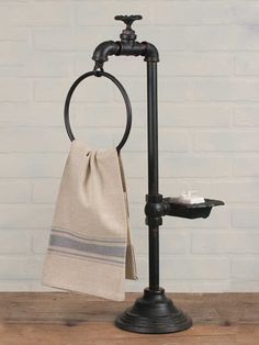 towel and soap holder on wooden table with brick wall in the background, text reads towel and soap holder spigot scp and towel holder