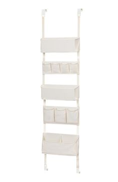 a white shelf with four bins and two shelves on each side, in the shape of a ladder