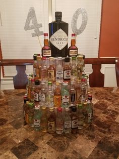 a large amount of liquor bottles are stacked on top of each other