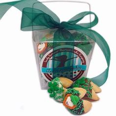 some cookies are in a clear box with green ribbon