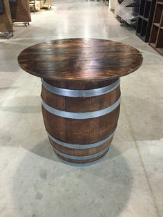 a table made out of wine barrels in a warehouse