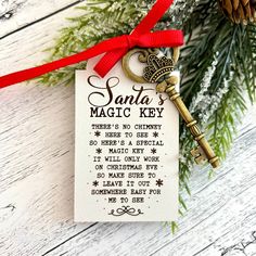 a key to santa's magic key is hanging from a christmas ornament