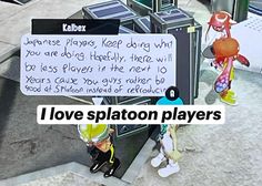 two people standing next to each other on a sidewalk with a sign that says i love splaton players