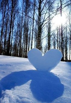 a heart shaped object is in the snow