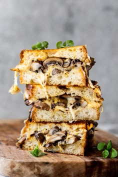 three slices of bread stacked on top of each other with mushrooms and cheese in them