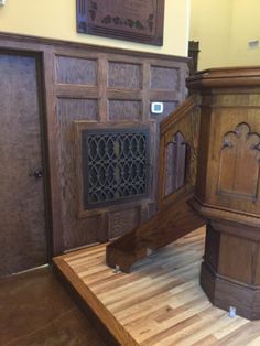 an old church pulpit with wooden paneling and carvings