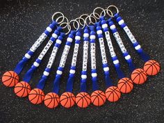 a bunch of basketballs that are on some kind of keychain with name tags attached to them